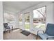 Cozy sunroom with neutral carpet, bright natural light, and inviting views of the outdoors at 5933 Guilford Ave, Indianapolis, IN 46220
