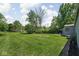 Expansive backyard with lush green grass, mature trees, and well-maintained lawn at 6223 N Parker Ave, Indianapolis, IN 46220