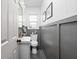 Updated bathroom featuring a stylish vanity and gray wainscoting for a modern and clean aesthetic at 6223 N Parker Ave, Indianapolis, IN 46220