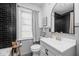 Stylish bathroom featuring updated fixtures, black-tiled shower, and modern vanity at 6223 N Parker Ave, Indianapolis, IN 46220