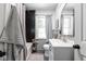 Tastefully updated bathroom with black tiled shower, gold fixtures, and stylish mirror at 6223 N Parker Ave, Indianapolis, IN 46220