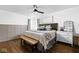 Elegant bedroom boasts hardwood floors, a cozy bed, and a matching bench with wall design at 6223 N Parker Ave, Indianapolis, IN 46220