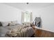 Bright bedroom with hardwood floors, corner windows, and neutral decor at 6223 N Parker Ave, Indianapolis, IN 46220
