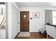 Cozy entryway featuring hardwood floors, a wood door with round window, and stylish decor at 6223 N Parker Ave, Indianapolis, IN 46220