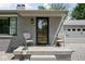 Inviting front porch with stylish chairs and modern black frame front door at 6223 N Parker Ave, Indianapolis, IN 46220