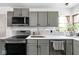 Bright kitchen featuring stainless steel appliances, and gray cabinets, and quartz countertops at 6223 N Parker Ave, Indianapolis, IN 46220