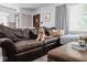 Cozy living room features a brown leather couch, neutral walls, and natural light at 6223 N Parker Ave, Indianapolis, IN 46220