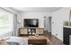 Comfortable living room with modern TV console, hardwood floors, and a neutral color palette at 6223 N Parker Ave, Indianapolis, IN 46220
