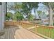 A wooden deck, part of a fenced yard with trees, perfect for outdoor entertaining and privacy at 625 N Temple Ave, Indianapolis, IN 46201