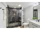 Stylish bathroom with a glass-enclosed shower featuring marble-look tiles and modern fixtures at 625 N Temple Ave, Indianapolis, IN 46201