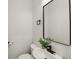 Modern powder room features a sleek vessel sink, black fixtures, and a minimalist aesthetic, with natural elements at 625 N Temple Ave, Indianapolis, IN 46201