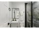 Modern bathroom with tiled shower, gray vanity, and black hardware accents at 625 N Temple Ave, Indianapolis, IN 46201