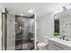 Modern bathroom with tiled walk-in shower, floating shelves, and elegant sink and vanity at 625 N Temple Ave, Indianapolis, IN 46201