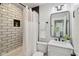 Modern bathroom featuring subway tile shower, marble countertop, and black fixtures providing a sophisticated design at 625 N Temple Ave, Indianapolis, IN 46201