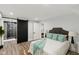 Stylish bedroom featuring hardwood floors, modern ensuite bathroom, and neutral color scheme at 625 N Temple Ave, Indianapolis, IN 46201
