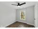 Bright bedroom with window, hardwood floors, and neutral paint, offering a blank slate at 625 N Temple Ave, Indianapolis, IN 46201