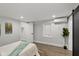 A cozy bedroom featuring light walls, wood-look floors, and a modern mini-split AC unit at 625 N Temple Ave, Indianapolis, IN 46201