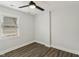 A bright bedroom featuring neutral paint, modern ceiling fan, wood-look flooring, and natural light from a window at 625 N Temple Ave, Indianapolis, IN 46201
