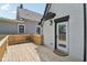 A spacious wooden deck with a glass door providing seamless indoor-outdoor living and entertaining at 625 N Temple Ave, Indianapolis, IN 46201
