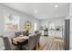 Bright dining room with a modern table setting, large window, and open access to the kitchen at 625 N Temple Ave, Indianapolis, IN 46201