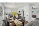 Open dining room with gray tufted chairs and an eat-in kitchen with stainless steel appliances at 625 N Temple Ave, Indianapolis, IN 46201
