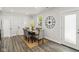Bright dining room with a wooden table, six chairs, and a decorative clock on the wall at 625 N Temple Ave, Indianapolis, IN 46201