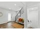 Clean and bright entryway with a staircase, bench seating, and modern design elements at 625 N Temple Ave, Indianapolis, IN 46201