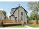 Two-story home featuring a chimney and a new wooden deck perfect for outdoor entertaining at 625 N Temple Ave, Indianapolis, IN 46201