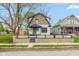 Charming two-story home featuring stone accents, a modern black roof, and a well-kept front yard at 625 N Temple Ave, Indianapolis, IN 46201