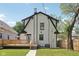 Rear exterior of home with a deck and black and white trim at 625 N Temple Ave, Indianapolis, IN 46201