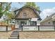 Charming two-story home features a stone accent wall, a freshly painted exterior, and a well-manicured front yard at 625 N Temple Ave, Indianapolis, IN 46201