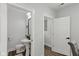 Well-lit half bathroom with pedestal sink, modern fixtures, and clean, minimalist design at 625 N Temple Ave, Indianapolis, IN 46201