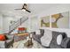 Bright living room boasts hardwood floors, a staircase, and an open layout that offers space for entertaining at 625 N Temple Ave, Indianapolis, IN 46201