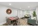 Spacious open concept living and dining space with hardwood floors and access to an ensuite bedroom at 625 N Temple Ave, Indianapolis, IN 46201