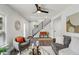 Bright living room boasts hardwood floors, a staircase, and an open layout that offers space for entertaining at 625 N Temple Ave, Indianapolis, IN 46201