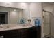 Modern bathroom featuring double sinks, dark cabinets, and a shower at 6304 Frst Brk Dr, Indianapolis, IN 46259