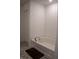 Bathroom featuring a corner tub, tile floor, and white cabinets at 6304 Frst Brk Dr, Indianapolis, IN 46259
