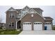 Charming two-story home featuring a brick facade, attached two-car garage, and well-maintained front lawn at 6304 Frst Brk Dr, Indianapolis, IN 46259