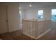 Upstairs hallway with white banister, natural lighting, and neutral carpet at 6304 Frst Brk Dr, Indianapolis, IN 46259