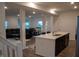 Bright open-concept kitchen with stainless steel appliances, island with sink, and hardwood floors at 6304 Frst Brk Dr, Indianapolis, IN 46259