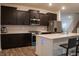 Modern kitchen with dark cabinetry, stainless steel appliances, quartz countertops, and a kitchen island at 6304 Frst Brk Dr, Indianapolis, IN 46259