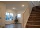 Bright living room featuring hardwood floors, large windows, and staircase at 6304 Frst Brk Dr, Indianapolis, IN 46259