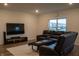 Relaxing living room with plush reclining sofa, entertainment center, and neutral rug for a cozy feel at 6304 Frst Brk Dr, Indianapolis, IN 46259