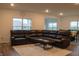 Comfortable living room with plush sectional sofa, neutral rug, and large windows for ample natural light at 6304 Frst Brk Dr, Indianapolis, IN 46259