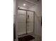 Modern shower with sliding glass doors, chrome fixtures, and neutral tiling at 6304 Frst Brk Dr, Indianapolis, IN 46259