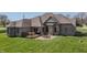 Aerial view of backyard featuring a deck, a stone patio and a well-manicured lawn on a sunny day at 6472 Independence Ct, Pendleton, IN 46064