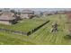 Aerial view of a home with a large, fenced backyard featuring a playground, lush greenery and patio furniture at 6472 Independence Ct, Pendleton, IN 46064