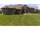 Brick home exterior featuring a spacious backyard with a deck and patio seating area for outdoor enjoyment at 6472 Independence Ct, Pendleton, IN 46064