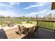 Backyard deck area overlooking spacious fenced in yard with manicured lawn and mature trees at 6472 Independence Ct, Pendleton, IN 46064