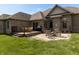 Brick home exterior featuring a spacious backyard with a deck and patio seating area perfect for outdoor dining at 6472 Independence Ct, Pendleton, IN 46064